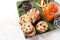 Tasty cookies, bowl with chocolate chips and jar of persimmon jam on table