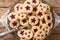 Tasty cookies sandwich with jam. Traditional Austrian pastries Linzer. Close-up on a plate. Horizontal top view