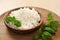Tasty cottage cheese served with basil on plate
