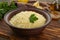 Tasty couscous with parsley on wooden board, closeup