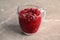 Tasty cranberry sauce in glass pitcher