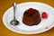 Tasty Creme caramel dessert or Coffee Flan with cherries and a metal spoon on a plate