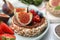 Tasty crispbreads with chocolate, figs and sweet berries on plate, closeup