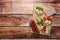 Tasty crispbreads, cucumber, tomatoes and basil on wooden table, flat lay. Space for text