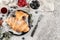 Tasty croissants with jam and berries on light table