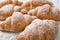 Tasty croissants on parchment, closeup