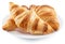 Tasty crusty croissants on the plate on white background. File contains clipping path