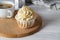 Tasty cupcake with almond flavor frosting with cup of coffee