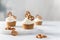 Tasty cupcakes with cream cheese decorated with brezel on white marble board on light background. Party, happy birthday, pastry,