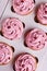 Tasty cupcakes with pink cream in cardboard box