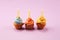 Tasty cupcakes on pinke background. Birthday cupcake in rainbow
