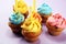 Tasty cupcakes on pinke background. Birthday cupcake in rainbow