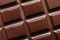 Tasty dark chocolate bar as background