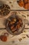 Tasty dates on a round substrate close-up on a wooden background. Top view