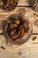 Tasty dates on a round substrate close-up on a wooden background. Top view