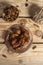 Tasty dates on a round substrate close-up on a wooden background. Top view