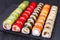 Tasty delicious multicolored appetizing sushi rolls set served o