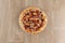 Tasty delicious pizza pepperoni - salami on a wooden background