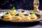 Tasty delicious tartlets with black caviar on a luxurious platter