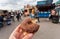 Tasty donut in hand of visitor of street food market of Copenhagen, Denmark. Leisure in Scandinavia with drinks, food