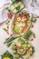 Tasty Easter food served on white table background, top view. Various eggs plates. Funny Bunny rabbit and chicken made with boiled