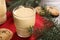 Tasty eggnog, cookies and fir branches on wooden table, closeup