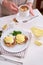 Tasty eggs Benedict, hollandaise sauce and aspargus covered with bacon