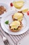 Tasty eggs Benedict, hollandaise sauce and bacon