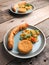 Tasty falafel with spicy bulgur and a vegetarian dough roll on a wooden table