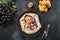 Tasty fall pie galette with plum and apricot on black table