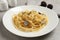 Tasty fettuccine with truffle on light grey table