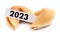 Tasty fortune cookies and paper with number 2023 on white background