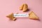 Tasty fortune cookies and paper with phrase Will you marry me? on pink background