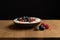 Tasty fresh blueberry raspberries  yoghurt shake dessert in ceramic bowl standing on black dark table background