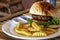 Tasty fresh burger and french fries on white plate served for lunch. Yummy kids food menu closeup photo.