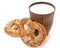 Tasty fresh just from oven crispy Brezel pretzel with brown ceramic glass of milk isolated