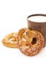 Tasty fresh just from oven crispy Brezel pretzel with brown ceramic glass of milk isolated vertical