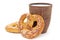 Tasty fresh just from oven crispy two Brezel pretzel with brown ceramic glass of milk isolated