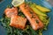 Tasty freshly cooked salmon with spinach on plate, closeup