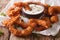 Tasty fried coconut shrimp close-up and cocktail sauce on the pa