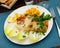 Tasty fried codfish served with endive, greens and corn