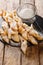 Tasty fried dough dessert wings of angels with powdered sugar close-up. vertical