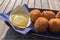 Tasty fried meat balls, served with mustard in a beach restaurant.