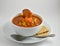 Tasty garden vegetable soup with spoon, bowl, and saltine crackers