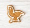 Tasty gingerbread bird shape on the wooden background