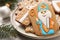 Tasty gingerbread cookies and festive decor on table, closeup. St. Nicholas Day celebration
