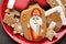 Tasty gingerbread cookies on red plate, top view. St. Nicholas Day celebration