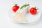 Tasty goat cheese with rosemary and tomato, on white table