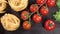 tasty green fresh lettuce red cherry tomatoes yellow Tagliatelle rotating on black wooden table close up view from top