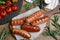 Tasty grilled sausages served on wooden table